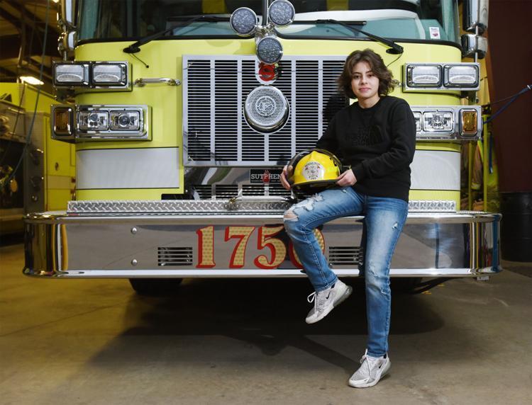 Amelia Heppler seated at the front of a fire truck